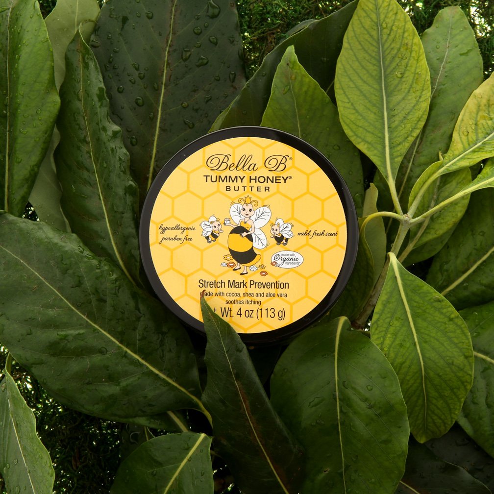 Bella B Tummy Honey Butter container surrounded by green leaves