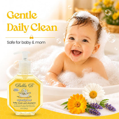 Baby in a bath with a bottle of Bella B baby wash and shampoo, surrounded by flowers.