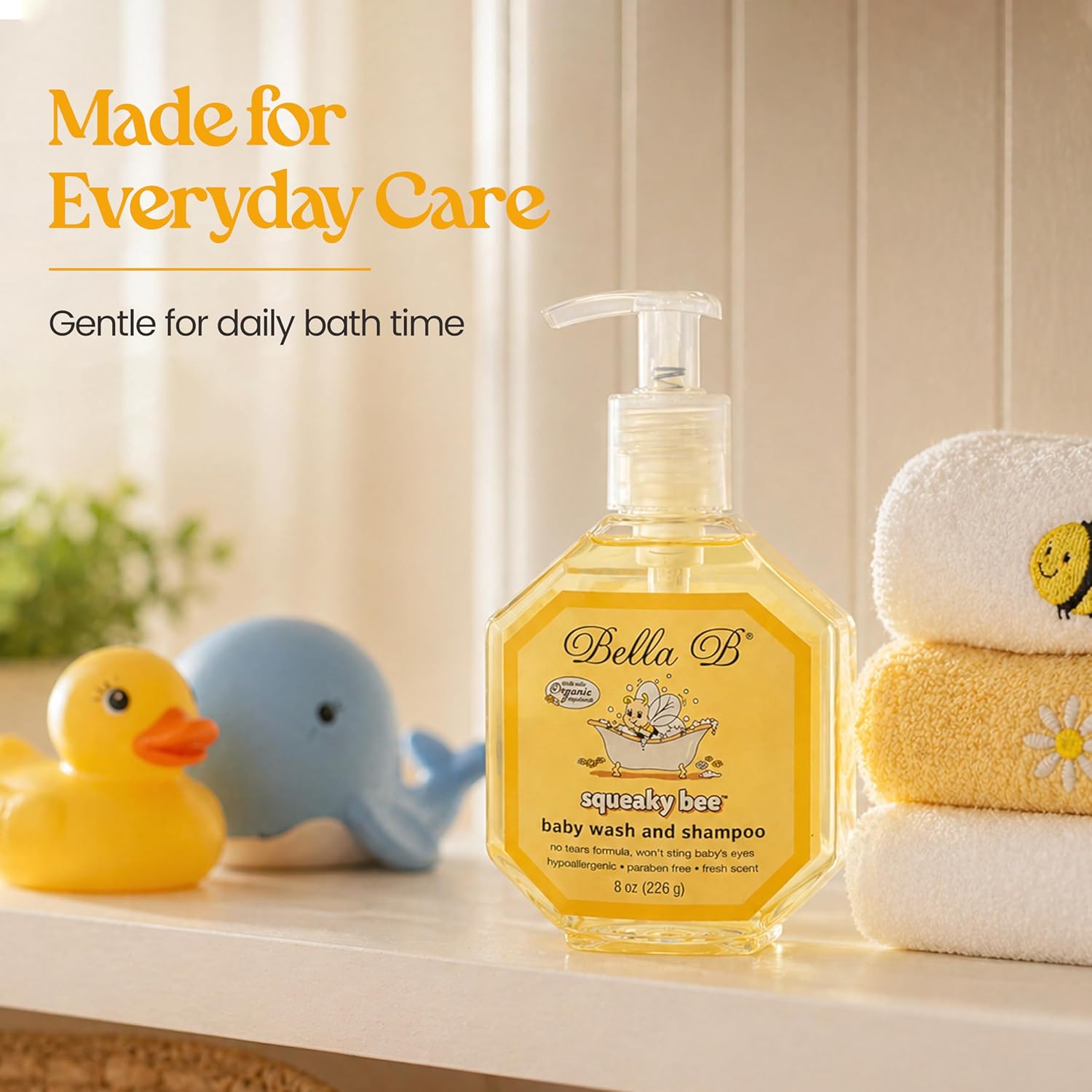 Bella B baby wash and shampoo bottle with bath toys and towels on a shelf